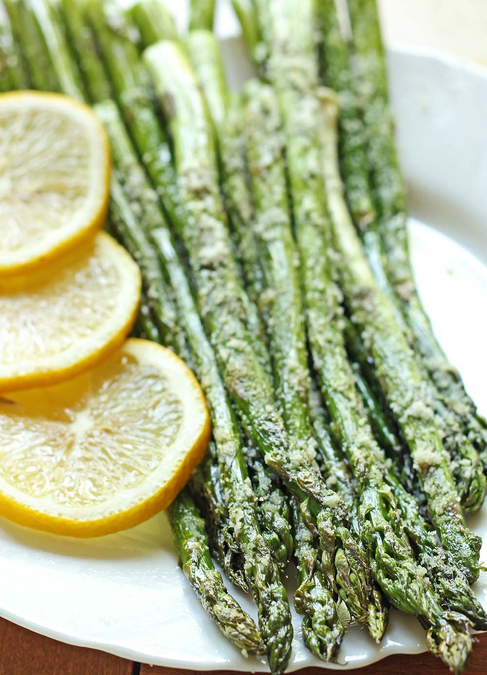 A perfect side dish, fresh asparagus baked to perfection and topped with parmesan and garlic and made with just 5 min prep!