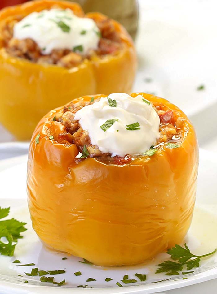 Old fashioned stuffed bell peppers were a staple in our family when I was a kid and they find the way onto my family’s table now. They are an inexpensive comfort food that can be made in the oven, crockpot, or top of stove. There are a lot of variations but here is how I like them. They are wonderful to make and freeze as well.