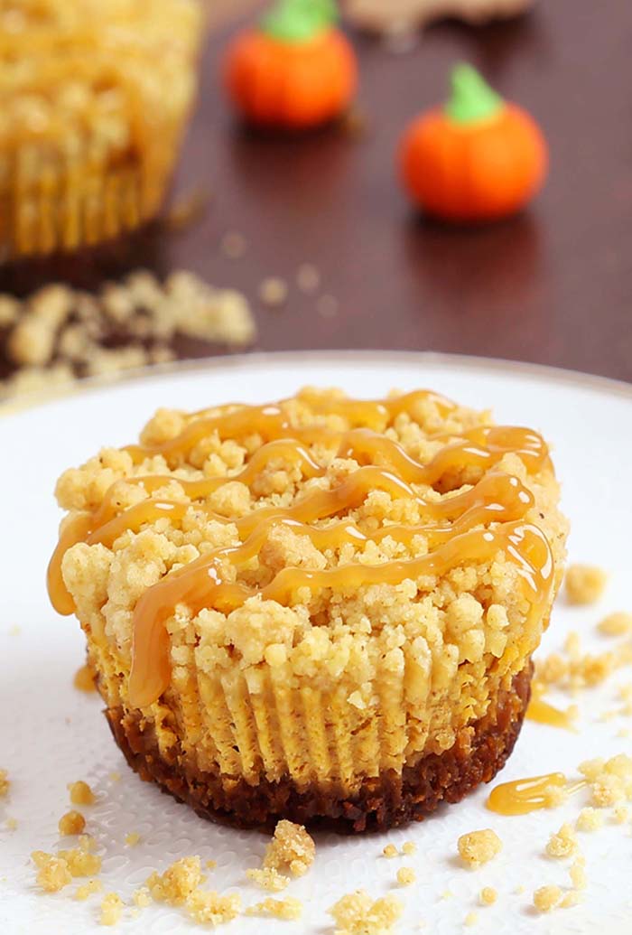 Caramel Pumpkin Mini Cheesecakes with Streusel Topping  are what pumpkin dessert dreams are made of! A irresistible gingersnap cookie crust with a rich, smooth, creamy pumpkin cheesecake filling, topped with crunchy, sweet, buttery streusel and caramel sauce.