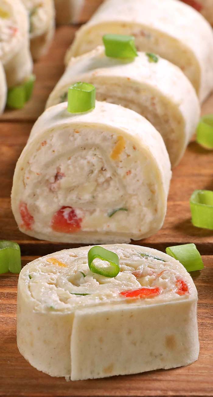 Chicken Enchilada Tortilla Roll Ups are a simple and fun bite sized spin on ever popular chicken enchiladas! A great appetizer recipe, easy to make ahead, easy to serve, perfect for game day party !