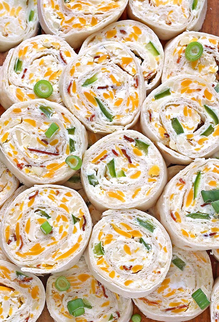 Jalapeno Popper Tortilla Roll Ups are a simple and fun bite sized spin on ever popular jalapeno poppers! Always a crowd pleaser, perfect for game day party.