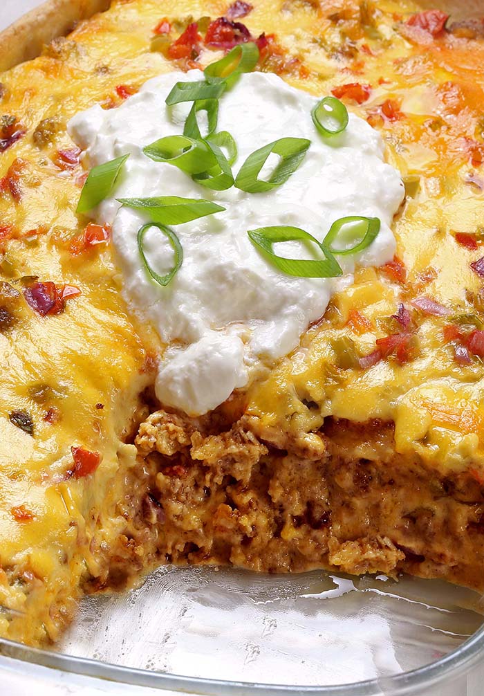 Need an easy recipe to feed a crowd? Taco Lasagna is layered casserole with tortillas, taco seasoned ground beef, pico de gallo sauce or salsa and cheese. Perfect for busy nights!