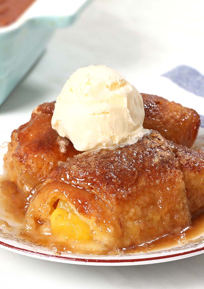 Crescent Roll Peach Dumplings are an easy dessert made with peaches, crescent dough, a brown sugar butter sauce, and soda.