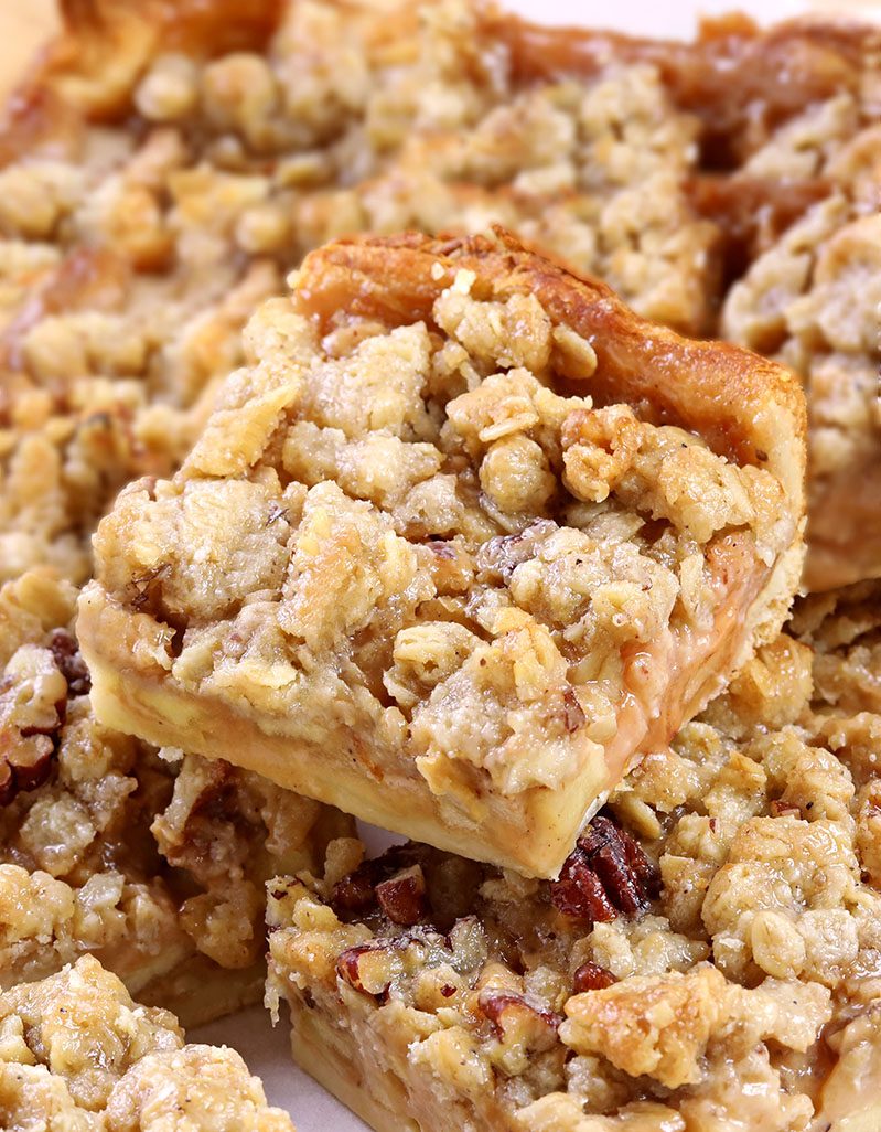 Caramel Apple Pie Bars are the perfect dessert: a Crescent dough crust with tender, warmly spiced, caramel-flavored apples and nutty crumble topping. They're great for Thanksgiving and Christmas and are an excellent alternative to Apple Pie!