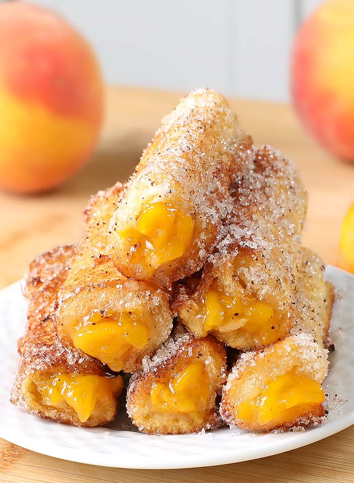 Tasty peach pie filling rolled inside the slice of bread, fried until golden brown and coated with cinnamon-sugar mixture. These delicious Peach Pie French Toast Roll-Ups are a creative breakfast treat for any day of the week!