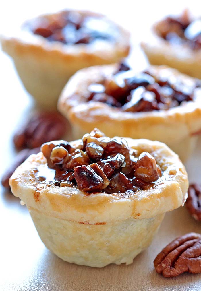 Delicious Mini Pecan Pie Bites is a quick and easy fall recipe full of gooey pecan filling and buttery crust. Perfect for Thanksgiving or Halloween and can be made ahead of time!