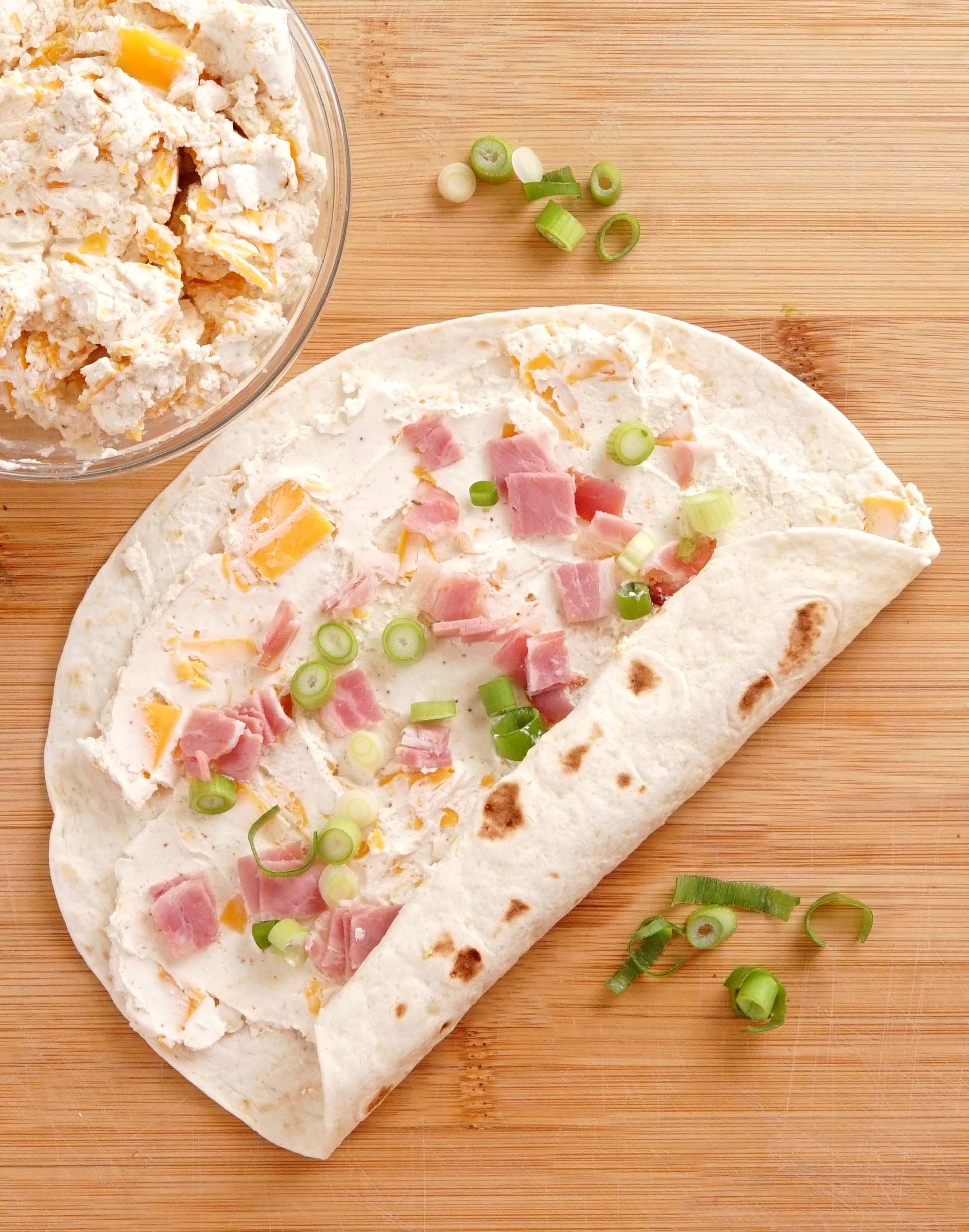 Fast, EASY, and a party FAVORITE!! Ham And Cheese Tortilla Roll-Ups are a must for Holidays or game day snacking.