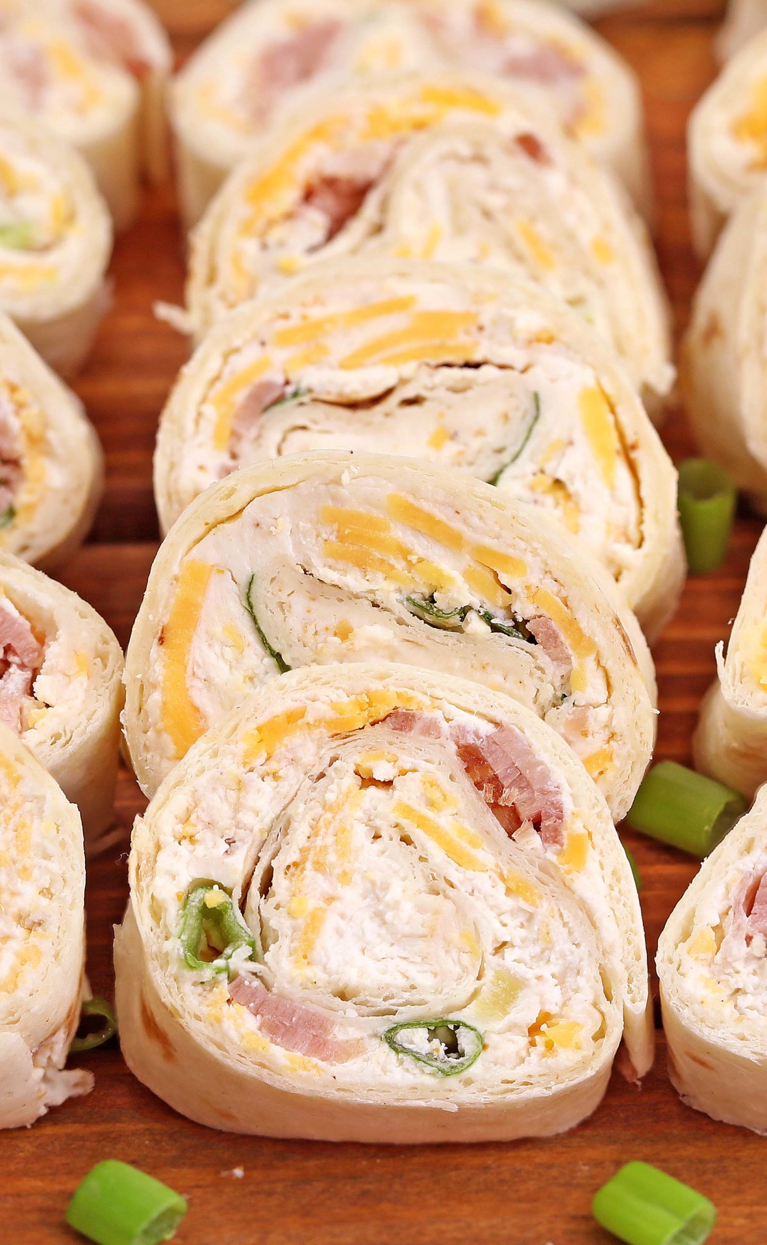Fast, EASY, and a party FAVORITE!! Ham And Cheese Tortilla Roll-Ups are a must for Holidays or game day snacking.