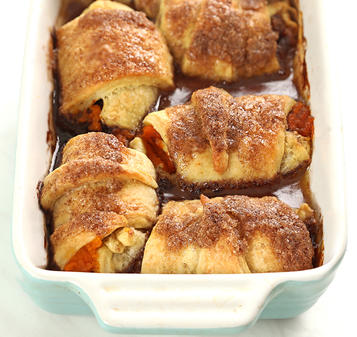Crescent rolls stuffed with pumpkin, spices, sugar, butter, and cream cheese, baked in brown sugar sauce and soda for the easiest and most delicious Crescent Roll Pumpkin Pie Dumplings!